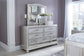 Coralayne Queen Upholstered Bed with Mirrored Dresser, Chest and 2 Nightstands Signature Design by Ashley®